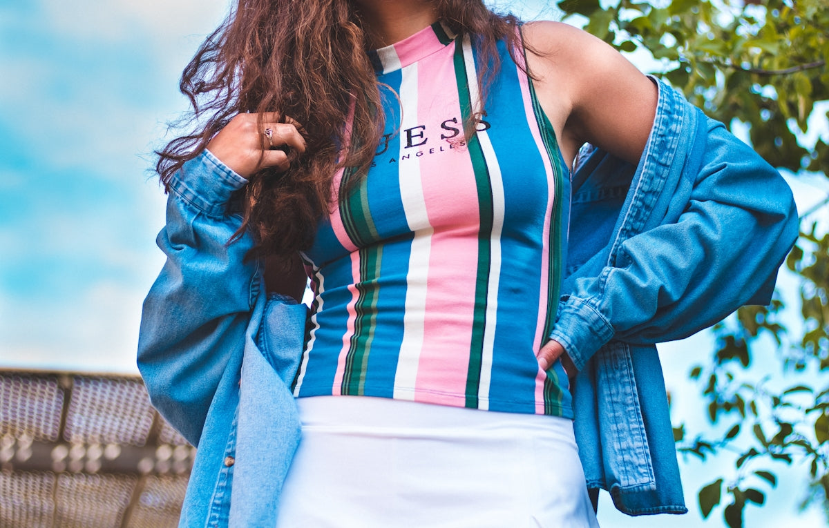 woman in white and red tank top and blue denim jacket