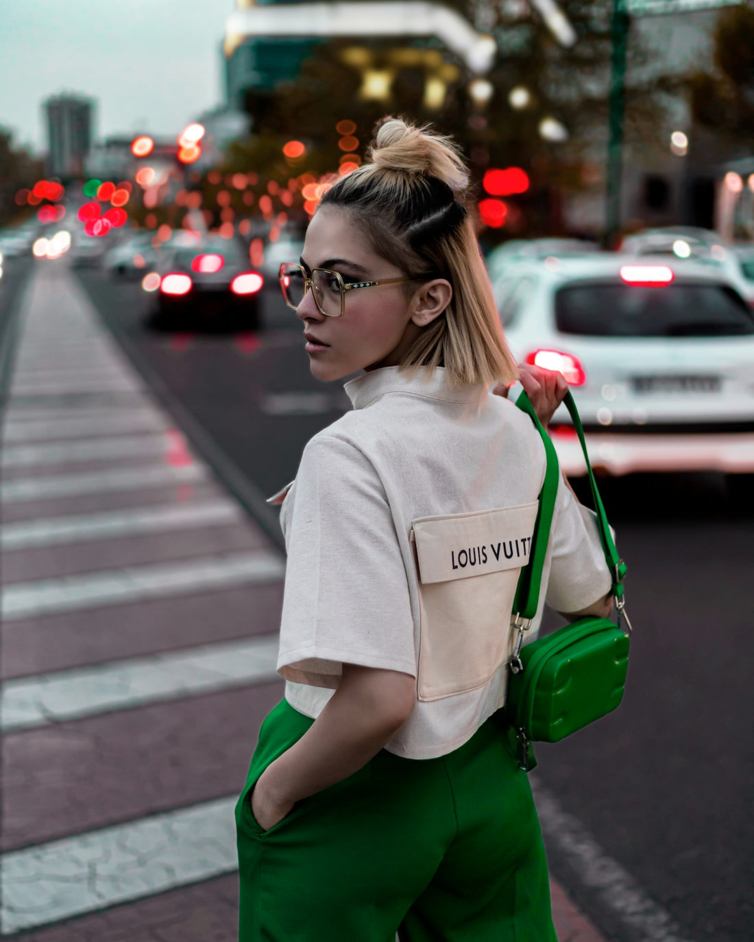 a woman standing on the side of a road