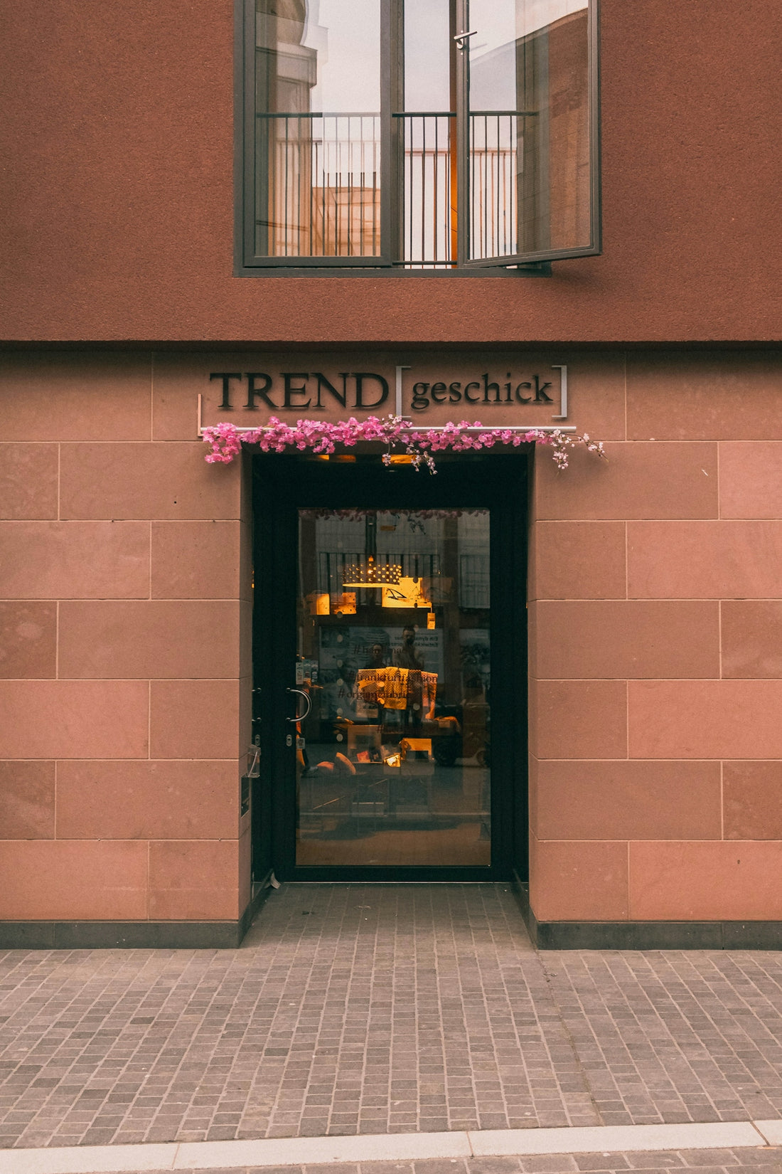 Storefront with trend geschick sign and display window.